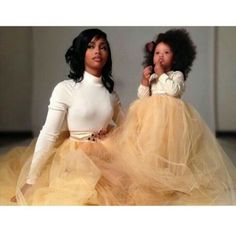 two dolls dressed in yellow tulle skirts, one is wearing a white top and the other has black hair