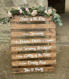 a wooden sign with flowers and greenery on it that says order of the day