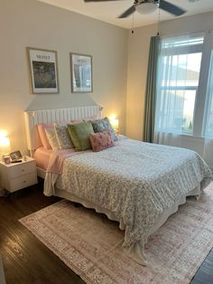 a bedroom with a bed, rug and ceiling fan