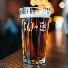 a pint glass sitting on top of a wooden table