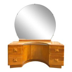 a wooden dresser with a round mirror on top