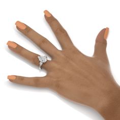 a woman's hand with an engagement ring on it