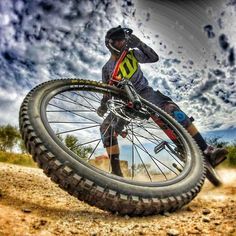 a man riding a bike on top of a dirt field