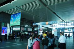 many people are walking through an airport terminal