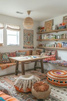 a room filled with lots of different types of pillows and rugs on the floor