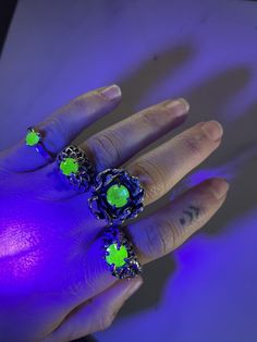 These rings are unique and make quite a statement! Made using sterling silver and antique uranium glass, each is one of a kind. Sizes can be changed up or down up to 2 sizes, if you need that changed please specify in the notes section at checkout. A - SIZE 9.5 B- SIZE 6.5 C - SIZE 6.5 D - SIZE 8 Uranium glass was popular in the late 1800s and early 1900s when a small amount of uranium was added to glass to strengthen it. Safe to humans and black light reactive, it went out of favor in the 1930s Luminous Silver Jewelry For Party, Silver Glow In The Dark Jewelry For Party, Silver Glow-in-the-dark Jewelry For Party, Green Luminous Jewelry For Party, Luminous Green Jewelry For Party, Green Luminous Round Jewelry, Hand Cast Green Jewelry Gift, Unique Hand Cast Green Jewelry, Hand Cast Green Jewelry For Gift