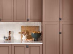 an image of a kitchen setting with brown cabinets and white counter tops in the background