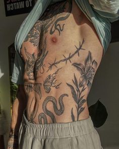 a man with many tattoos on his back