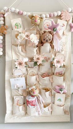 a white wall hanging with lots of items on it's sides and decorations around the edges