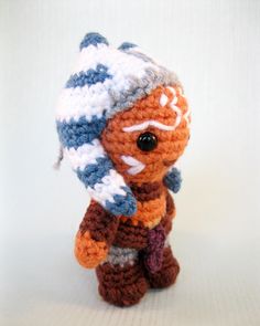 a small crocheted stuffed animal wearing a hat