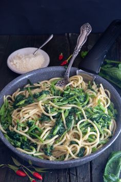 pasta with broccoli and white rice in a skillet on a wooden table