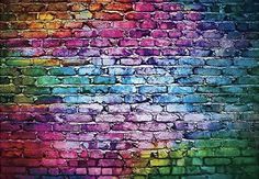 a brick wall painted in rainbow colors