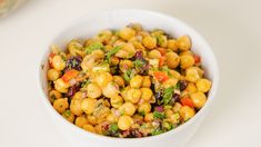 a white bowl filled with corn and vegetables