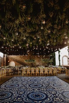 an elaborately decorated dining room with chandeliers and floral arrangements on the ceiling