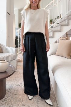 Crafted with soft and flowy linen, these effortless pants are perfect to bring along wherever you go this summer! The Santorini 100% Linen Trousers in Black feature a wide leg silhouette, woven linen fabric, black color, pleats, cuffed hemline, zipper and button closure. Style these pants with one of our basic tanks and a cardigan! Details & Sizing Wide leg Woven linen fabric Pleats Cuffed hemline Black color Zipper and button closure Gabriella is wearing a size S Fabric 100% Linen Dimensions S: Flowy Business Casual, Modern Minimalist Style Fashion, Wide Leg Linen Pants Outfit Fall, Black Gauze Pants Outfit, Wide Legged Black Pants Outfit, Linen Culottes Outfit, Uniqlo Wide Leg Pants Outfit, Linen Work Outfit, Black Linen Pants Outfit Work