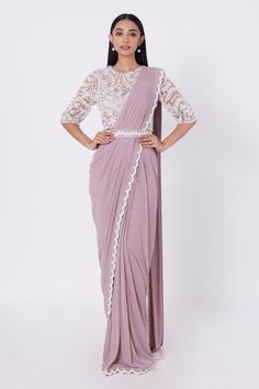 Mauve pre-draped saree with moti embroidery on the border. Comes with embroidered blouse and belt.
Components:3
Pattern:Embroidery
Type of Work:Moti
Neckline:Round
Sleeve Type:Half
Fabric:Lycra and Satin
Color:Purple
Other Details:
Scalloped border
Bead drops
Closure: Side zip
Note: Inner crop top worn by the model is not for sale
Occasion:Wedding - Aza Fashions Floral Work Blouse, Pleated Saree, Moti Work, Draped Saree, Floral Work, Drape Saree, Satin Saree, Wear Crop Top, Pattern Embroidery