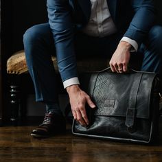 THIS collection is especially for him. The Tyler Brief is the perfect combination of rugged texture + handsome lines. Made from both bison + cow hide leathers, the messenger bag is the perfect carry all. Our heavy strap crossbody strap sits either crossbody or on your shoulder distributing the weight comfortably. Every Tyler Brief is unique due to our hides natural color variations + texture. Truly a work of art! Dimensions: 17" x 12" x 2.5" Features : -zippered closure -button flap -2 outside f Leather Lining Crossbody Briefcase For Business, Leather Lined Crossbody Briefcase For Business, Business Crossbody Briefcase With Leather Lining, Rugged Shoulder Bag With Leather Lining For Business, Leather Crossbody Briefcase For Work, Rugged Leather-lined Satchel For Business, Rugged Satchel Business Briefcase, Rugged Satchel Briefcase For Business, Rugged Business Satchel With Leather Lining