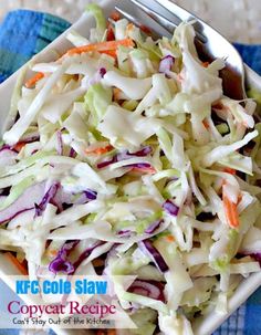 a white bowl filled with coleslaw on top of a blue and white towel