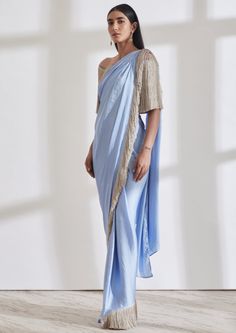 Our noor fringe sari features a full pre-draped sari that looks like a regular sari with our signature fringe detail. Pair it with the off shoulder fringe top or get in touch for more blouse options. Bollywood Style Pre-draped Saree With Tassels For Party, Elegant Saree With Tassels For Reception, Bollywood Blouse Piece With Tassels In Traditional Drape, Bollywood Blouse Piece With Traditional Drape And Tassels, Festive Saree Blouse Piece With Tassels, Pre-draped Saree With Tassels For Wedding, Traditional Party Saree With Tassels, Elegant Festive Saree With Tassels, Elegant Pre-draped Saree With Tassels For Festive Occasions