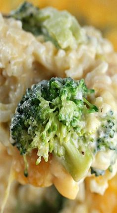 broccoli and pasta are being held up by a fork with cheese on it