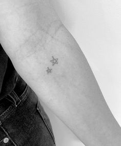 a small star tattoo on the left arm