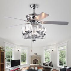 a living room filled with furniture and a ceiling fan