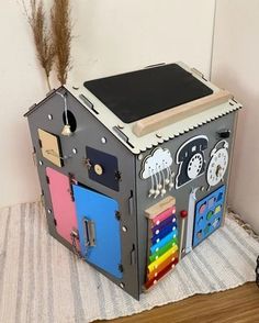 a toy house made out of cardboard on the floor