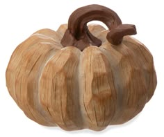 a carved wooden pumpkin on a white background