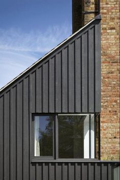 the side of a brick building with two windows