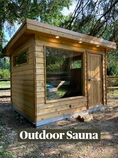 a small wooden shed with windows on the side and doors open to let in natural light