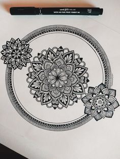 a drawing of a flower in a circle on top of a piece of white paper