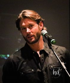 a man standing in front of a microphone