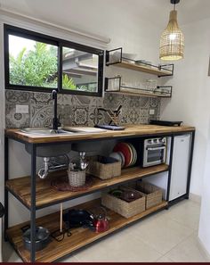 a kitchen area with shelves, sink and dishwasher