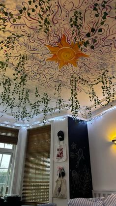 the ceiling is decorated with vines and sun lights in this bedroom, it looks like an art work