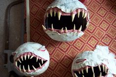 three decorated pumpkins with sharp teeth and fangs