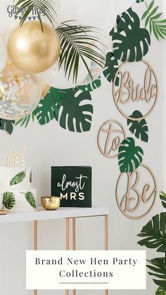 a party with palm leaves and gold decorations on the wall, including a sign that says bridal new he party collections