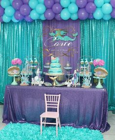 a table topped with lots of cake and balloons