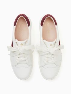 We think sneakers should be equally cute as they are comfortable. That's why we've given this pair playful feminine details sure to stand out whether you're commuting or running to the free cupcakes in the conference room. | Kate Spade Fez Sneakers, Optic White/cranberry - 10 Kate Spade Lace-up Sneakers With Branded Insole, Classic Sneakers With Leather Trim And Round Toe, Classic Sneakers With Leather Trim, Kate Spade Casual Low-top Sneakers, Kate Spade Outlet, Feminine Details, Cranberry, Conference Room, Kate Spade