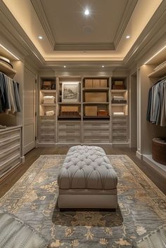 a large walk in closet with an ottoman