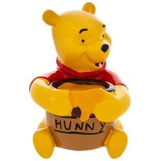 a winnie the pooh figurine sitting in a pot