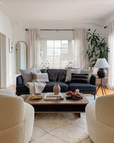 a living room with two couches and a coffee table in front of a window