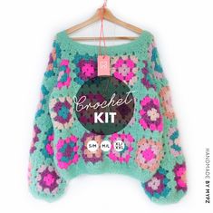 a crocheted sweater hanging on a hanger with the words brecket kit written across it