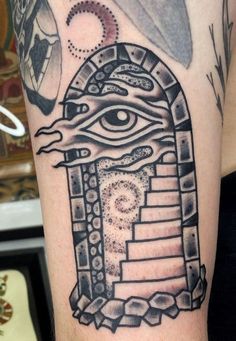 a tattoo with an eye and pyramid on it