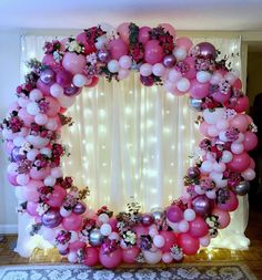 the balloon arch is decorated with pink, purple and white balloons that spell out paperbloom test