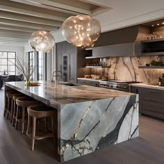 a large kitchen with marble counter tops and bar stools