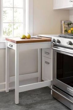 a kitchen with an oven, counter and window