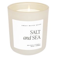 a white candle with the words salt and sea on it's label in front of a white background