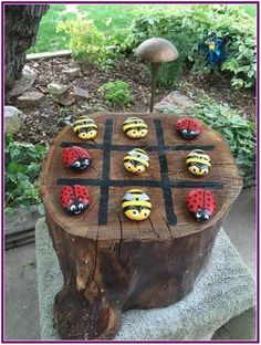 a wooden table with painted ladybugs on it