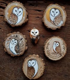 four wood slices with owls painted on them