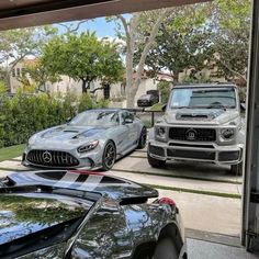 two mercedess parked in front of a house